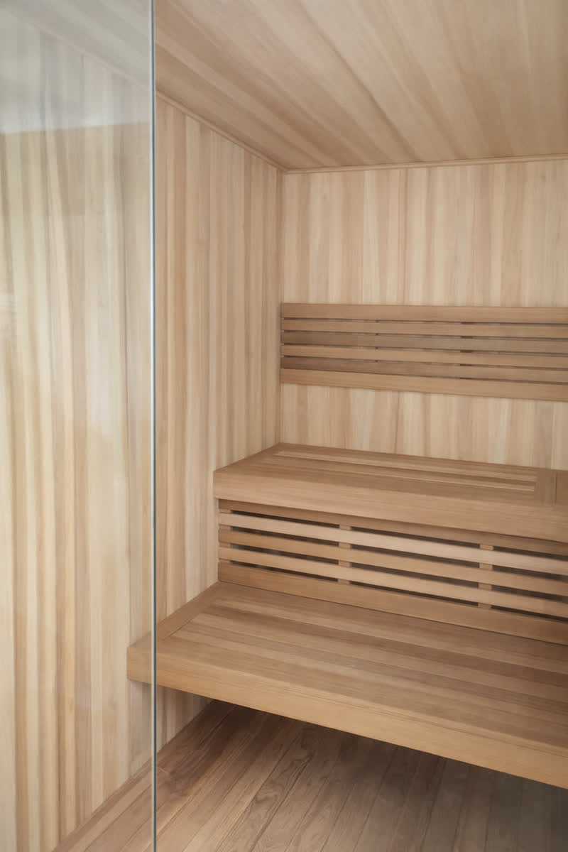 Compact sauna cabin interior in light timber, Bali
