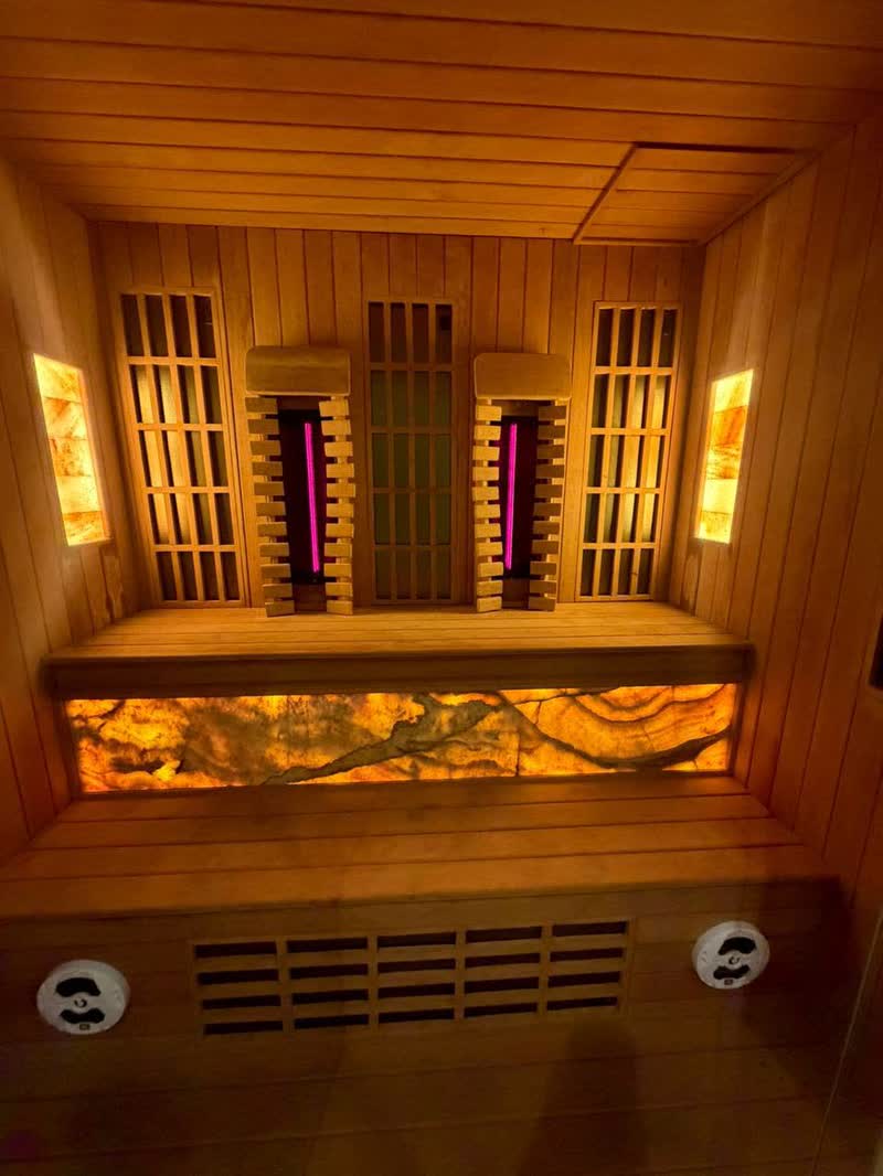 Infrared sauna cabin with backlit Himalayan salt panel in Bali